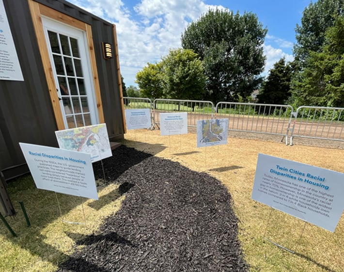 Signs at the exhibit describing racial disparities in housing