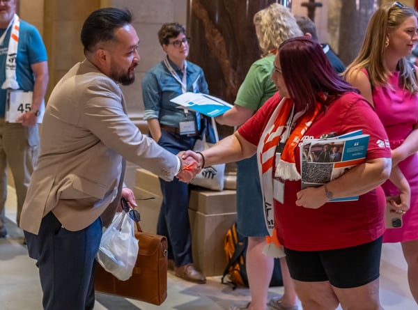 Supporters shaking hands at Habitat on the Hill in Minnesota.
