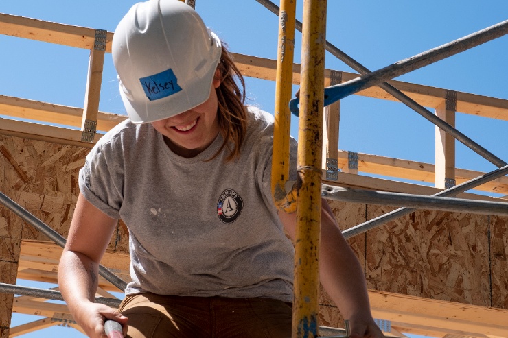 AmeriCorps member on scaffolding