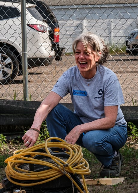Corinna laughing and smiling on a build site.