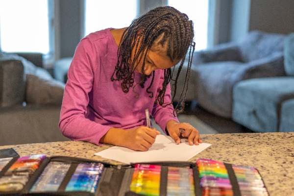 Layla Joy coloring at the kitchen counter.