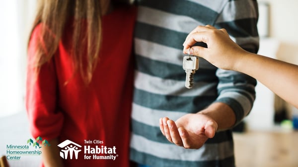 Close up of hand holding keys to a new home.