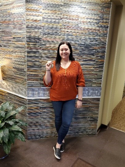Brittany holding the keys to her new house while at the Habitat office for her closing.