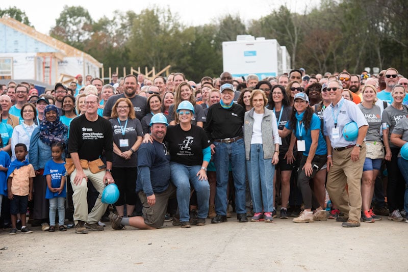 Large group photo from the 2019 Carter Work Project with President Carter and wife Rosalynn in the front.
