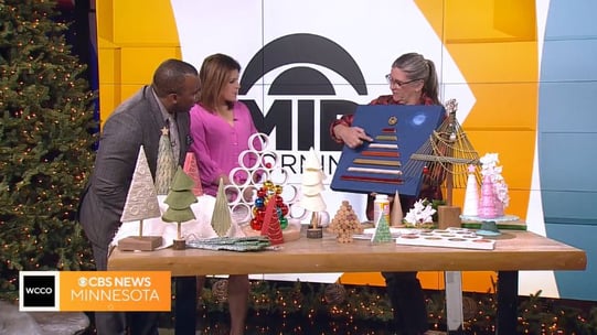 Jan and WCCO hosts with a variety of hand-made Christmas trees.