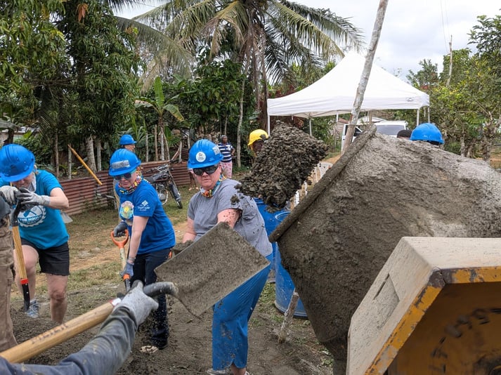 Volunteers mixing concrete in the D.R.