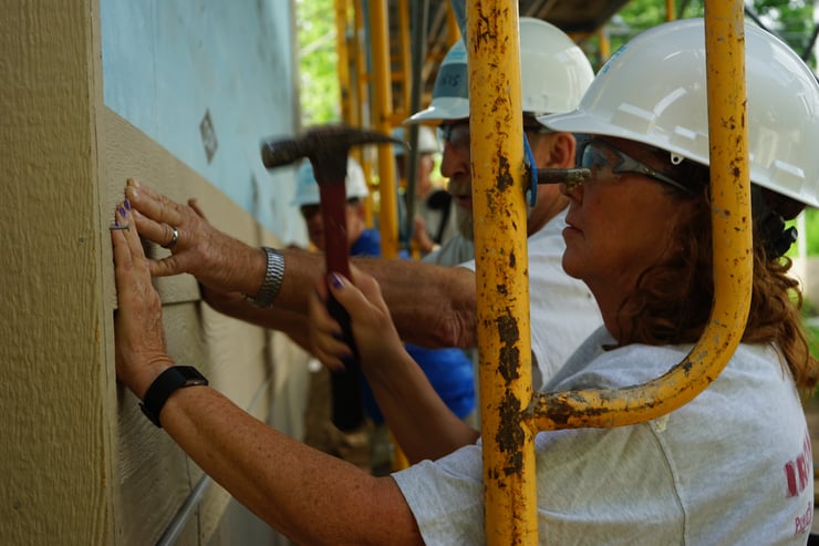 Builder's Circle volunteers installing some siding.