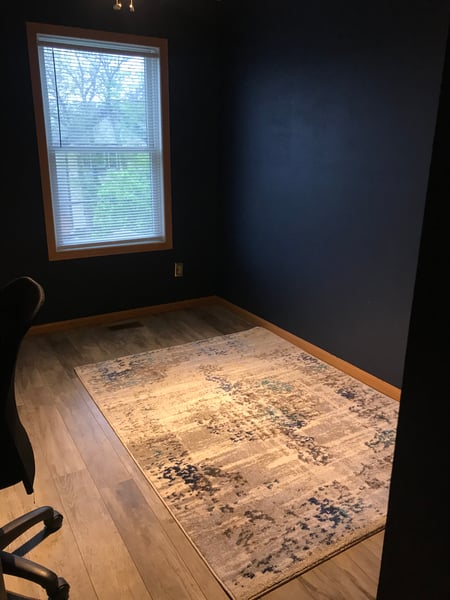 Office with floor rug.