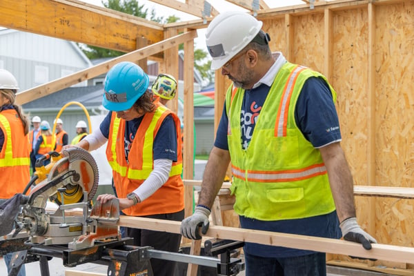 Volunteers using a table saw.