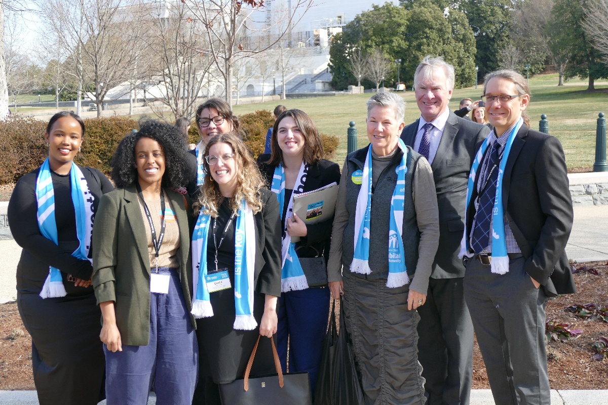 A picture of the Habitat on the Hill DC group standing in front of one of the Capitol Lawns