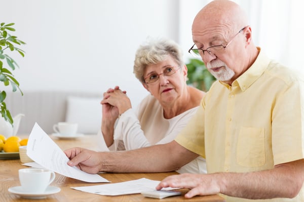 How Much Does it Cost to Age in Place_ - elderly couple, paperwork, cost, calculator