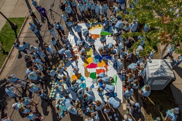 153 volunteers painting a map for National ABWK Week