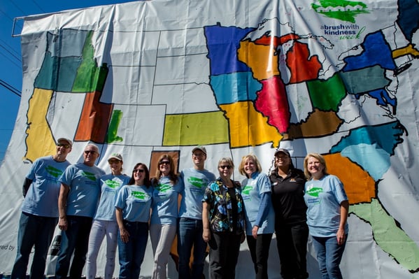 Nancy Finch (Hawaiian shirt) had her home painted to kickoff ABWK week