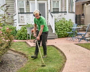 Man using a lawn trimmer.