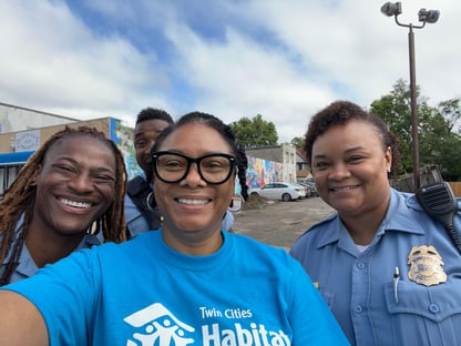 Shereese taking a selfie with three local police officers at the Live Your Healthy Lyfe event.