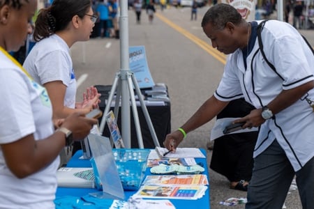 A man looking at booth materials.