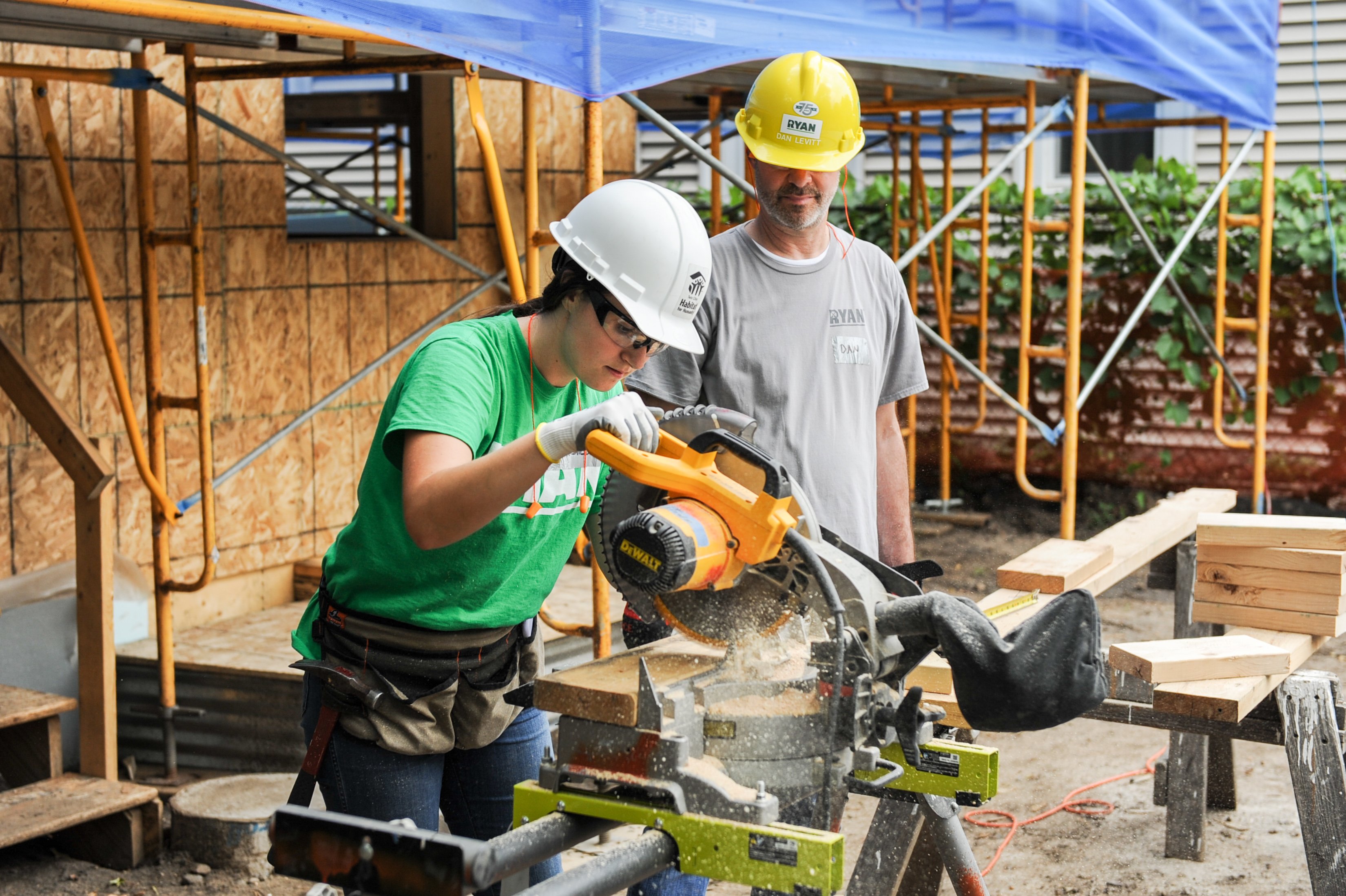 volunteer using saw