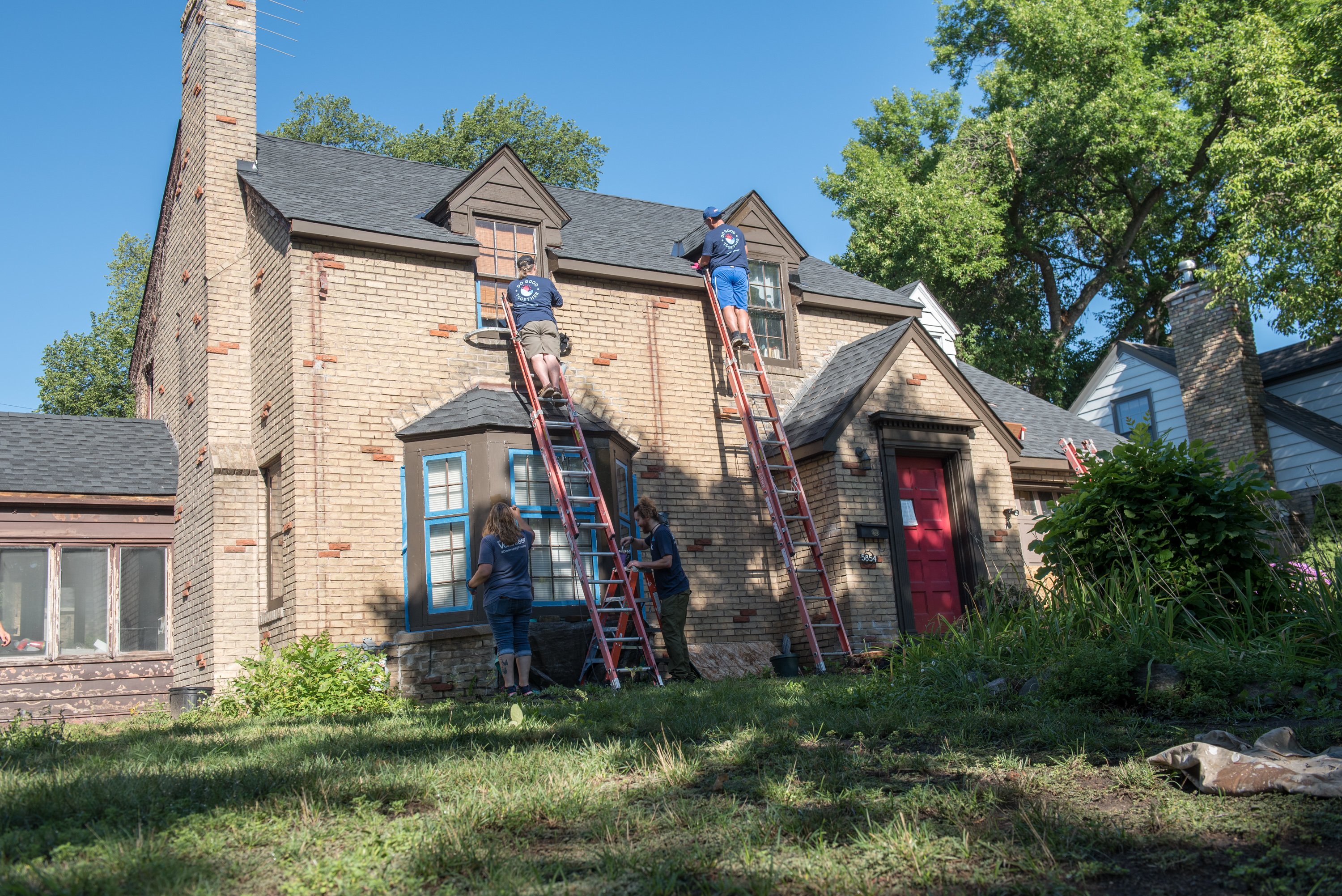 Volunteers on ladders.