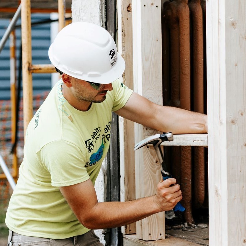 Volunteer with hammer.