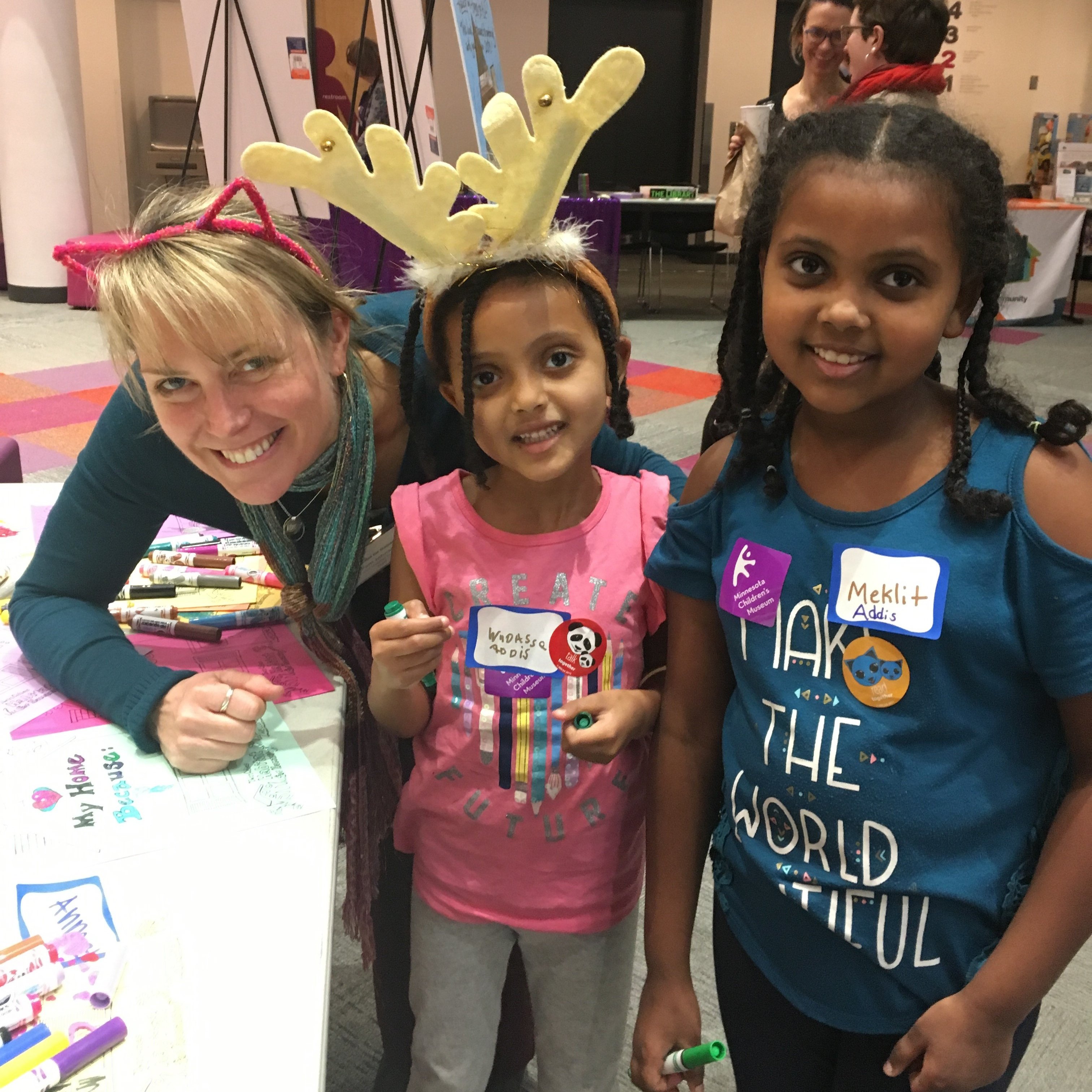 Pam with two children at a Habitat Family Event at the Children's Museum.