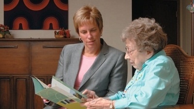 Two women reading about planned giving.