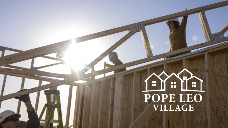 Construction volunteers on a house frame.