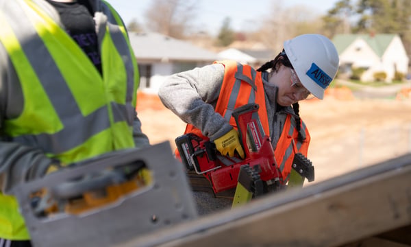 Volunteer using a nail gun.