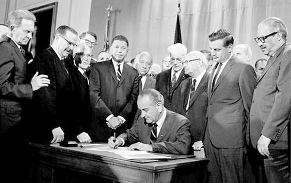 President Johnson signing Fair Housing Act in 1968. Walter Mondale looks (above to the right)