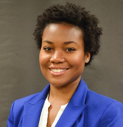 Shoree Ingram, the new Director of Equity and Inclusion, wearing a white shirt and bright blue jacket, smiling