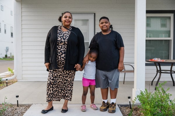 Habitat family outside their home.
