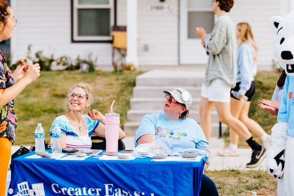 Tabling vendors talking with visitors.