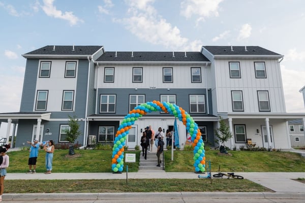 Exterior of The Heights homes with a balloon arch.