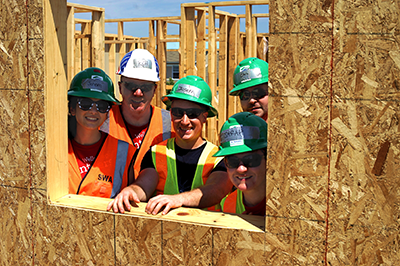 Volunteers smiling through window.