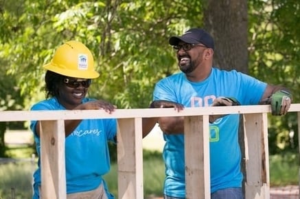 Two volunteers laughing.