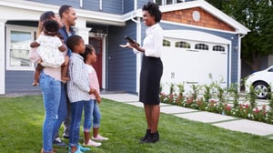 A Realtor showing a family a home.