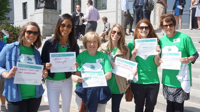 Housing_Heroes_at_the_Capitol_holding_their_Home_Is_signs