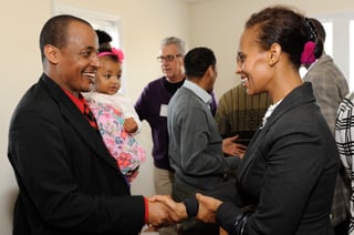 Samson, one of the two homebuyers being recognized at the dedication, is congratulated.