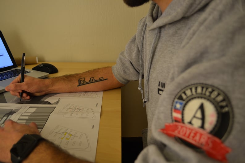 Greg works on an architecture project at his kitchen table.