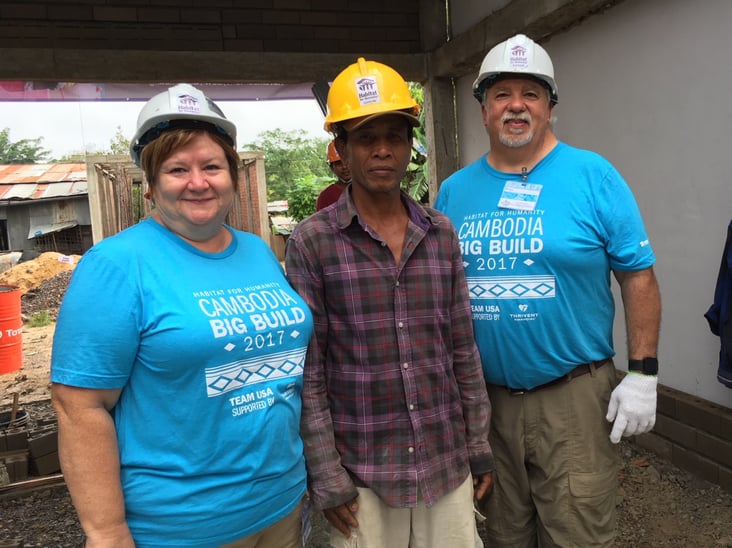 cambodia volunteers with homeowner.jpeg