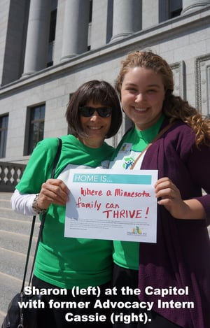 Sharon at the Capitol with former Advocacy Intern Cassie. Her sign says "Home is where a Minnesota family can thrive!"