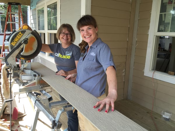 Robyn working on siding on a Habitat build site.