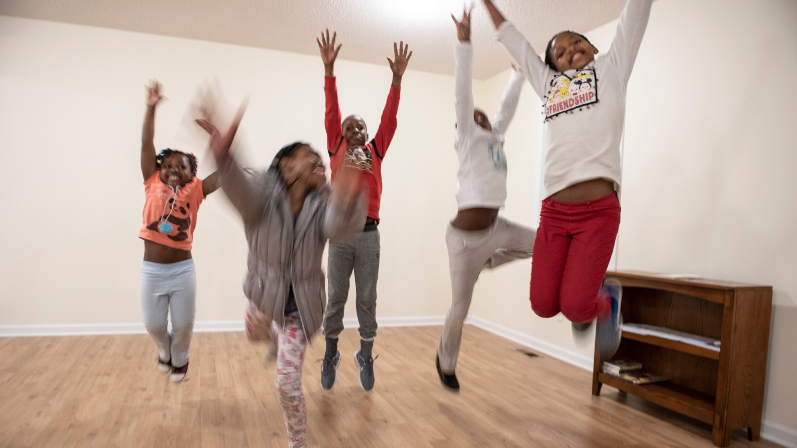 Kids jumping at a home dedication