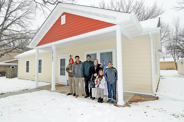 A family in front of their new Habitat home.