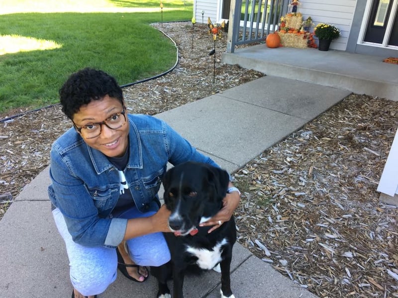 Shereese with her dog in the front yard