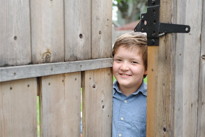 Erik peeking out from his fence