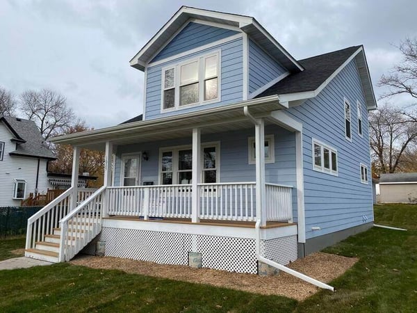 A blue finished Habitat home.