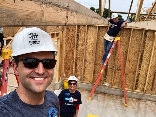 Jake poses with Representative Kristin Robbins (R-Maple Grove) and Representative Michael Howard (D-Richfield) at the Red Blue Build.