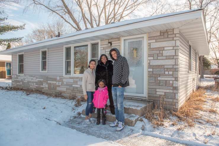 LaShonda's family stand in front of their Habitat home