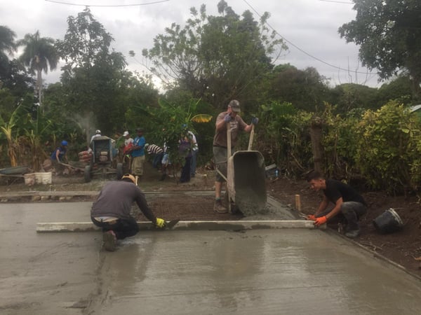 Volunteers pouring cement.
