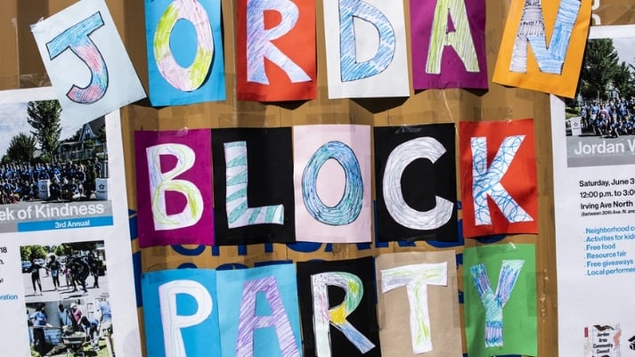 A colorful handmade sign for the Jordan block party.